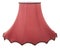 Classic gallery bell shaped tapered red lampshade on a white background isolated close up shot