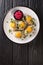 Classic Gefilte Fish Gently cooked fish patties in the simmering fish stock closeup in the plate. Vertical top view