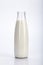 The classic glass bottle with milk on a white background