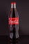 Classic glass Coca-Cola bottle with a volume of 0.33 liters isolated on a black background. Moscow, August, 2020