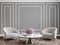 Classic gray interior with armchairs, coffee table, flowers and wall moldings.