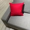 Classic gray sofa with vibrant red cushion