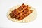 A classic Greek dish is souvlaki, small chicken kebabs. Fast food cooked on skewers and grills. Shish kebab on pita bread on a