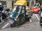 Classic green Piaggio APE three-wheeler parked on the street