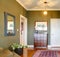 Classic Hallway with green walls, flowers and rug.