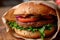 Classic Hamburger With Lettuce, Tomato, and Onion, A Tasty and Nourishing Meal, A close up image of a vegan burger wrapped in