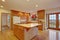 Classic hardwood kitchen with connected living room.