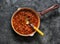 Classic homemade amatriciana tomato sauce in the cooking pan on a dark background, top view. Pasta bucatini amatriciana tomato