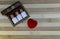 Classic homeopathy for  for healthy heart - Wooden box with homeopath medicine glass bottles of pills and heart on wood background