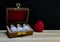 Classic Homeopathy for Heart â€“ Close view of homeopathy medicine bottles in wooden old box with red heart on wood and dark