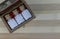 Classic homeopathy - Top view of wooden box with homeopathic medicine glass bottles on wood background