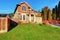 Classic house with garage, driveway, and grassy front yard.