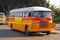 A classic iconic feature round orange Maltese public bus with shining chrome still in operation in capital city Valletta, Malta