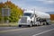 Classic industrial white semi truck transporting liquefied gas in a specialized high-pressure tank semi trailer driving on the