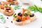 Classic Italian appetizer bruschetta with tomato, basil and black olives