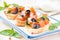 Classic Italian appetizer bruschetta with tomato, basil and black olives