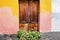 Classic Italian doors on walls painted pink and orange