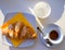 Classic italian espresso coffee served with homemade croissant cornetto and water