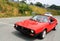 Classic italian sports car followed by modern fiat 500