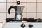 Classic Italian style moka coffee pot on the gas stove with fire