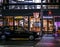 Classic japanese taxi in front of a pedestrian crosswalk and a few shops. Night photography