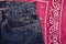 Classic jeans with five pockets close-up. Paisley patterned bandana, classic red and white neckerchief, biker head scarf. Rough