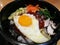 Classic Korea food vegetable Bibimbap hot stone pot, rice carrot, spinach, mushroom, cucumber, seaweed, fried egg and hot spicy ch