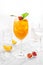 Classic lemonade mix in glass on white background with Sea buckthorn puree, cherry plums, soda and orange