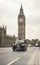 Classic London cab in front of Big Ben clock tower
