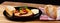 Classic meatloaf, cherry tomatoes, mozzarella, parsley, white bread in a black plate on a wooden background
