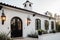 classic mediterranean house with black metal lanterns and white exterior