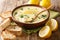 Classic Mediterranean lemon soup with chicken close-up in a bowl with bread. horizontal