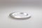 Classic metal stainless plate for restaurant or cafe view from the side on a light gray Pastel background. An excellent blank for