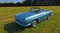 Classic metallic Blue Renault Caravelle Convertible parked in field