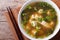 Classic miso soup in a white bowl close-up horizontal top view