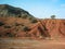 Classic Moroccan landscape - red mountain and argan trees