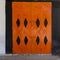 Classic Moroccan steel storage doors in orange and black on the street in Marrakesh, Morocco.