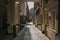 Classic narrow lane in London, with generic apartments architecture and cobblestone on the pavement.