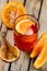 Classic negroni cocktail with orange slice in a glass on a wooden background with lines. garnished with orange slices and orange