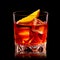 Classic Negroni in a crystal-cut rocks glass isolated on black backdrop