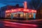 classic neon sign glowing on a vintage diner facade