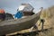 Classic New Zealand beach scene - bull dog guarding aluminium dinghy full of fishing gear