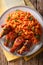 Classic Nigerian Jollofï¿½Rice with fried chicken wings close-up.