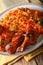 Classic Nigerian Jollofï¿½Rice with fried chicken wings close-up.