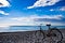 Classic old bicycle by the sea, blue sky with clouds, contrasting silhouette of a bicycle