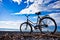 Classic old bicycle by the sea, blue sky with clouds, contrasting silhouette of a bicycle