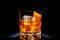 Classic Old Fashioned in a crystal-cut rocks glass isolated on black backdrop