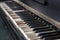 Classic old piano keys. The keyboard of a very old abandoned piano is covered with dust, some keys have dropped, some are absent