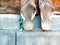 Classic old slippers hung on brick wall and part of wood wall. Mix vintage background between wood and brick.