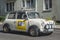 Classic old vintage small car white Morris Mini Cooper driving